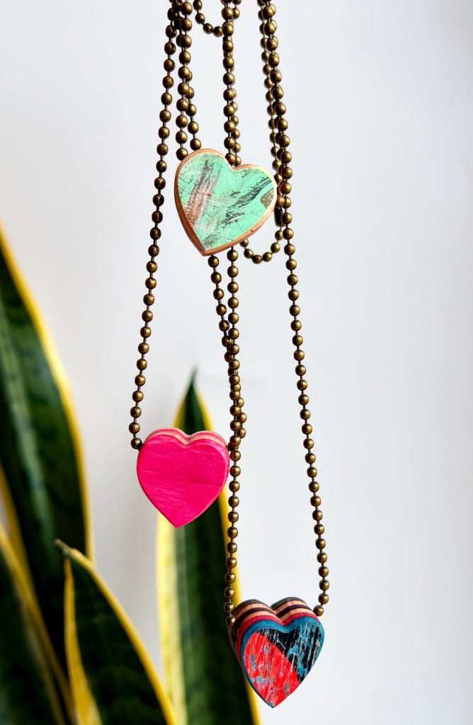 Necklace with heart-shaped colorful pendants on a white background